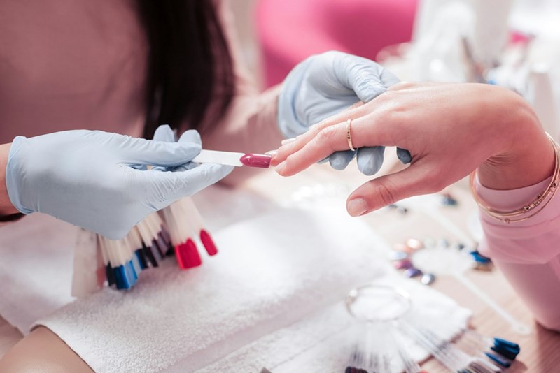 Nail tech doing a customer's nails.