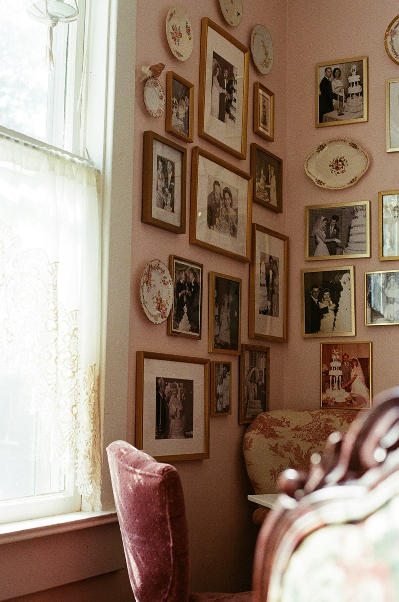 Framed family pictures displayed on a wall inside a home.