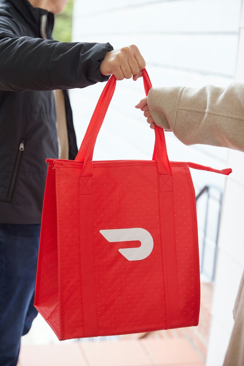 Food delivery order being handed to a customer.