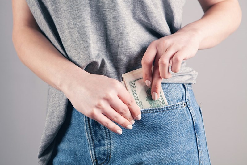 Person taking cash from a pocket.