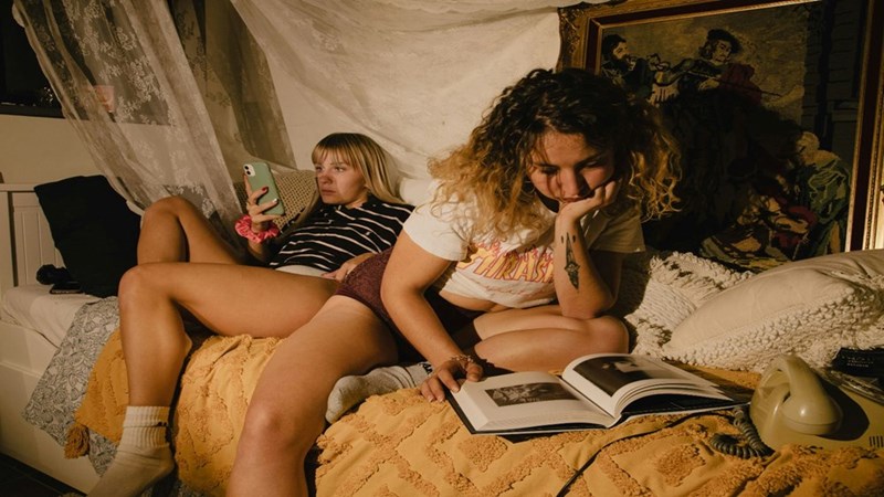 Two girls sharing a bedroom as roommates. Representation.
