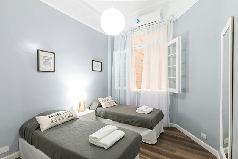 A bedroom with two single beds.