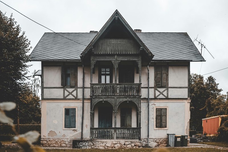 Exterior of an old historic home with vintage architecture and weathered details.