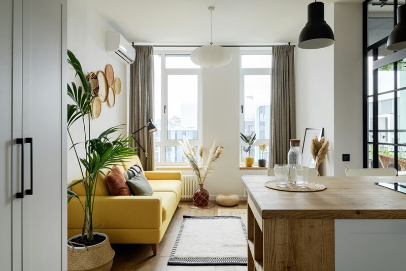 Bright, modern apartment living room with an open layout and contemporary furnishings.