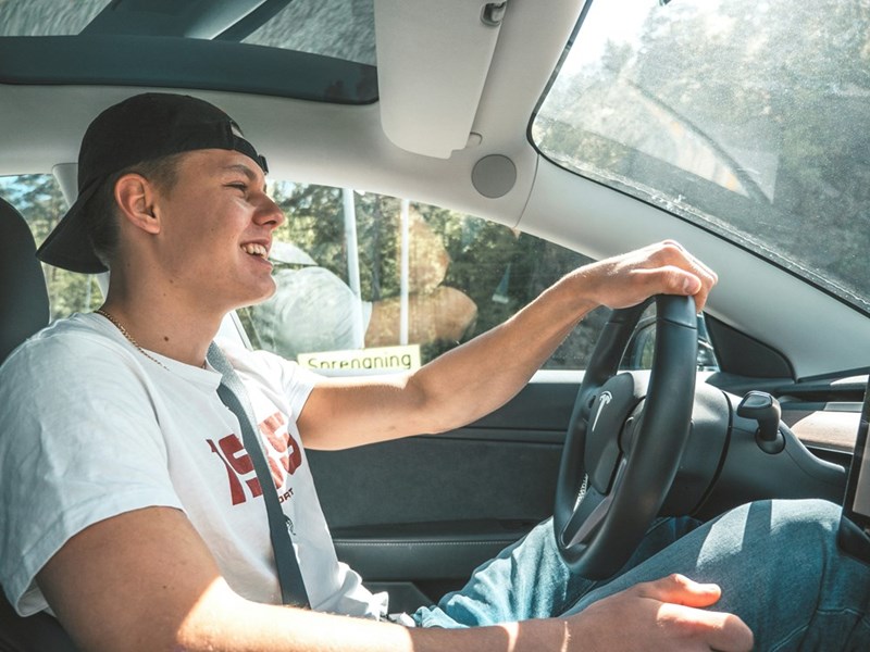 Young man driving a car, borrowing a family vehicle for short trips.