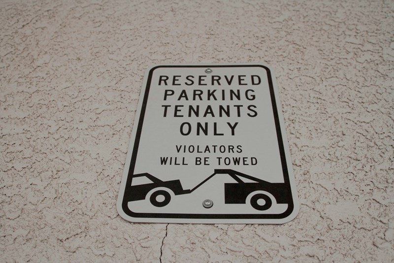 A reserved parking sign marks that parking is for tenants only.