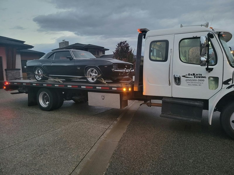 A coworker's car loaded onto a tow truck after being parked without permission.