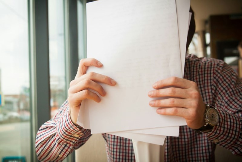person holding white paper