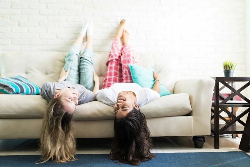 Two young roommates relax together at home before ongoing boundary issues over borrowed clothing begin affecting their living arrangement.