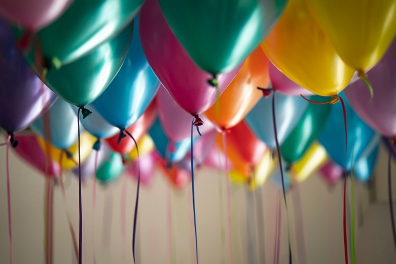 Balloons of different colors decorating a room.