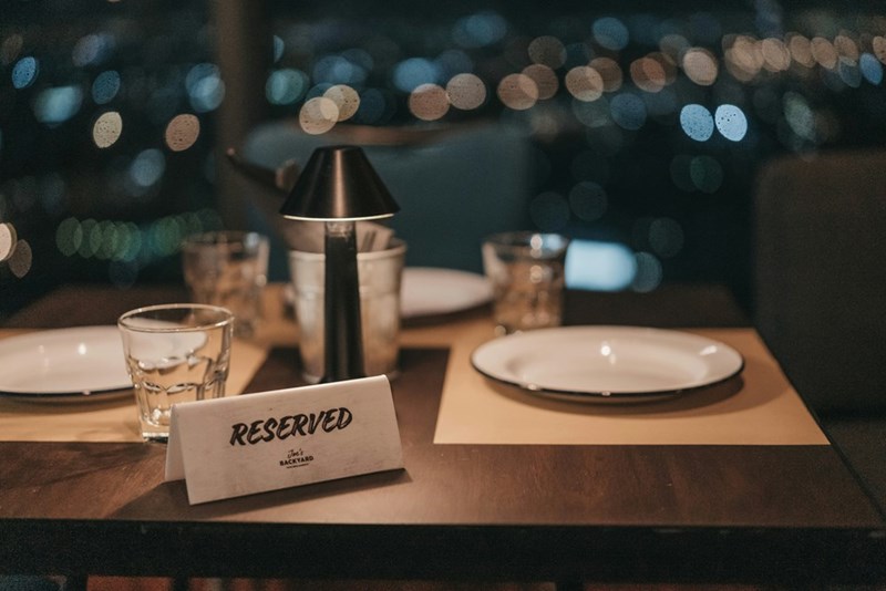 A table at a restaurant reserved for two people.