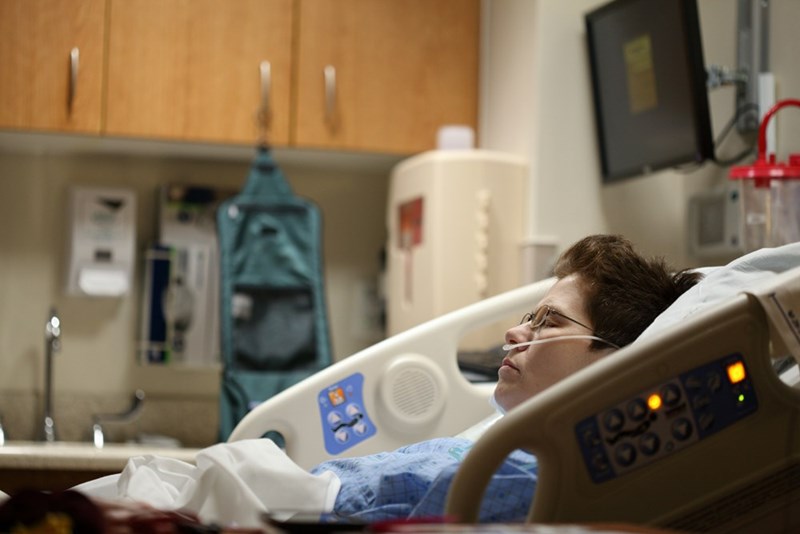 A patient lies in a hospital bed.