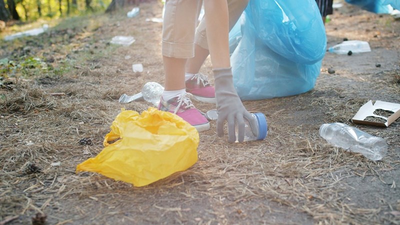 person picking up trash