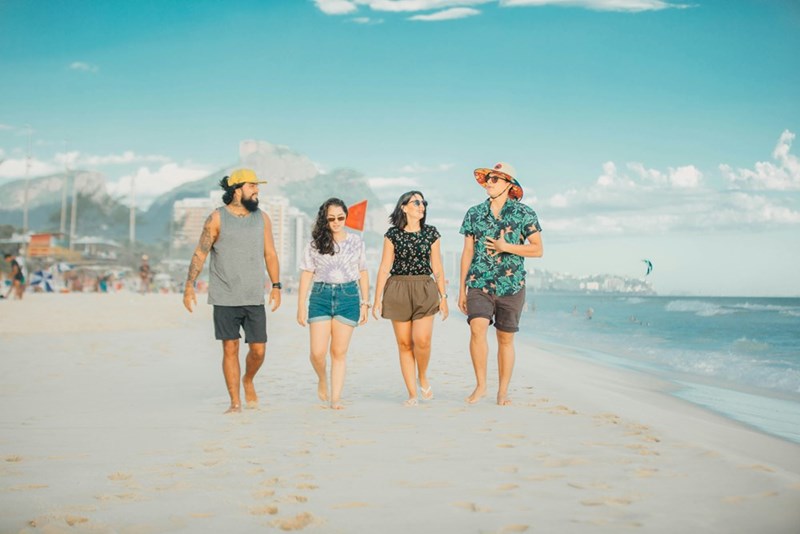People walking down the beach.