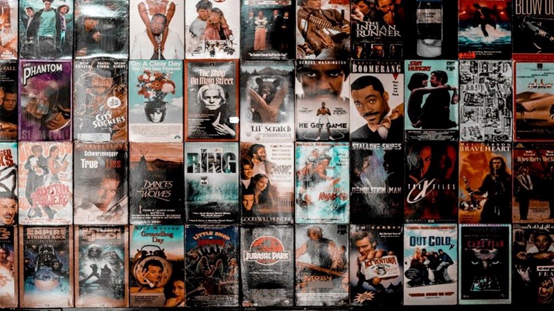Different movie DVDs displayed on a table.