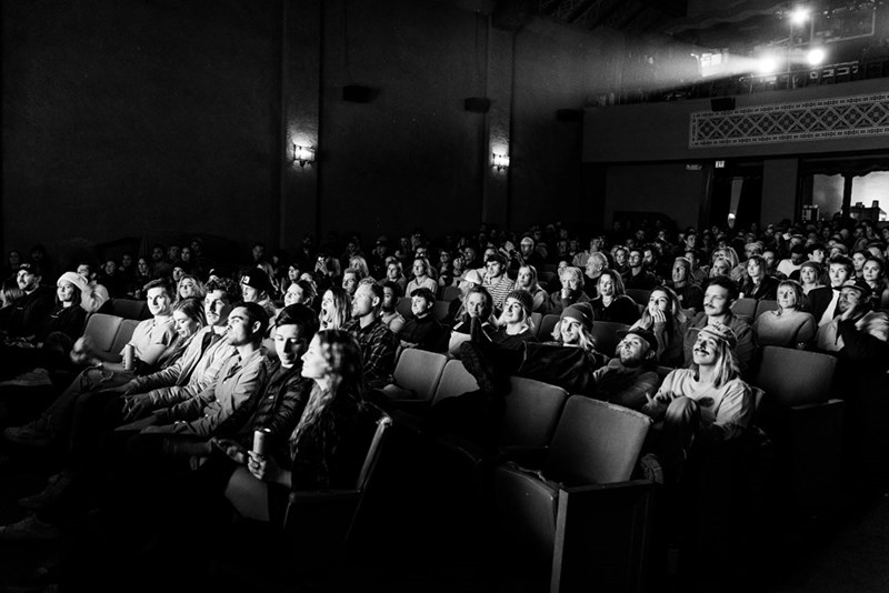A cinema full of people watching a movie.