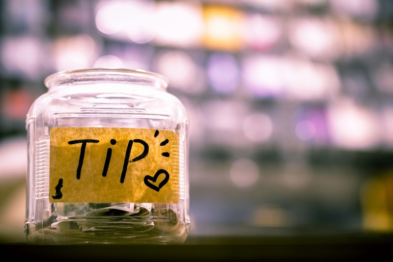 A tip jar with money in it.