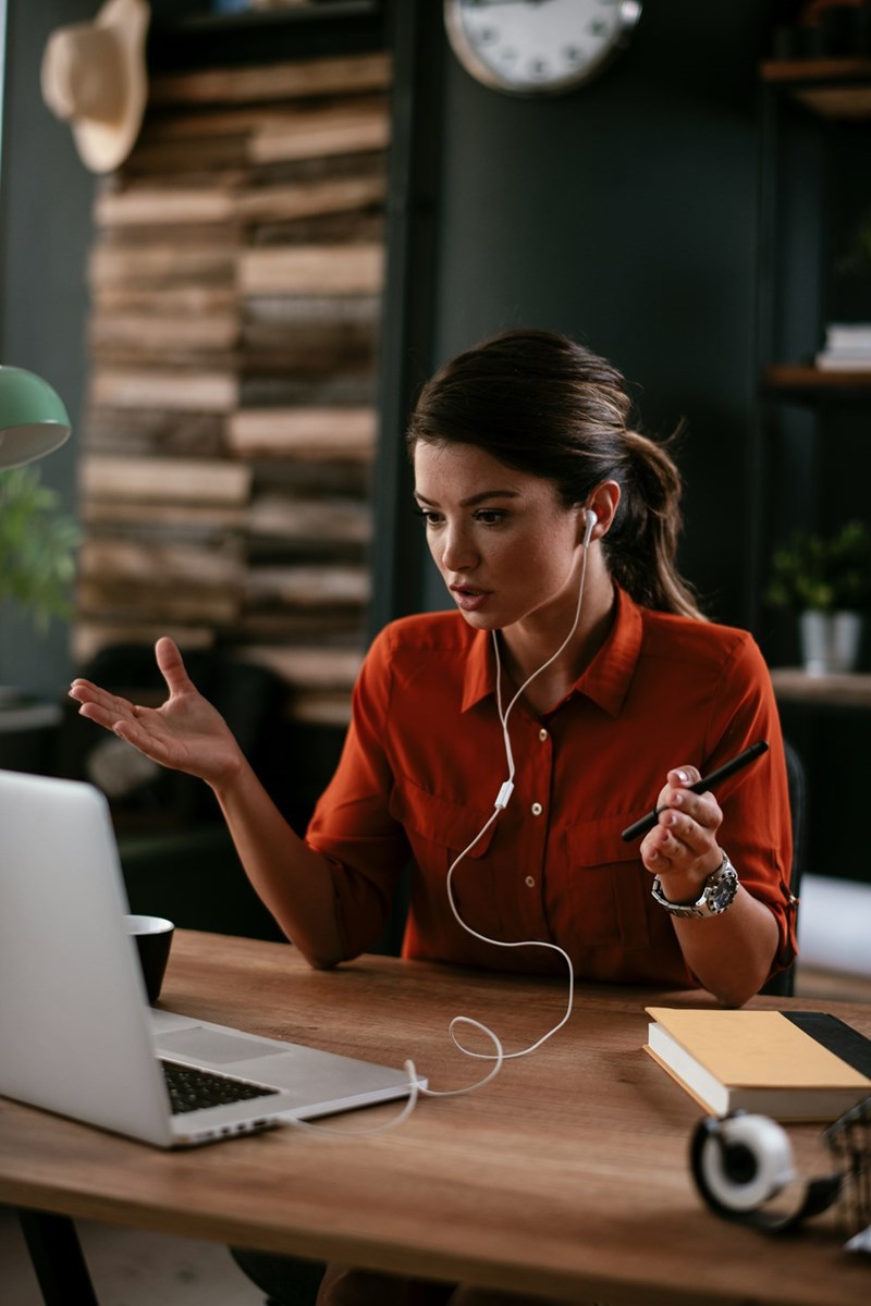 A woman gestures while on a video call