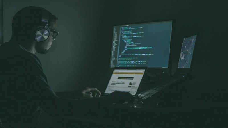A hacker hacking into a system with their computer. Representation.