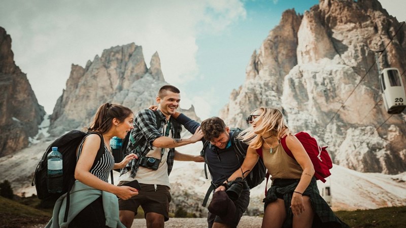 Two men and two women being playful on vacation. Representation.