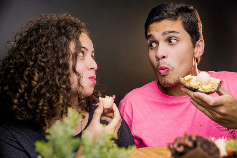 two people eating snacks