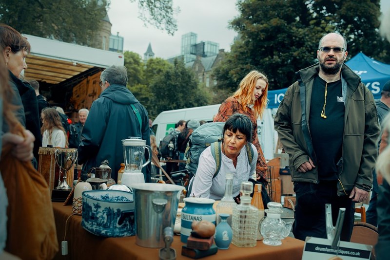 People browse items at an outdoor market