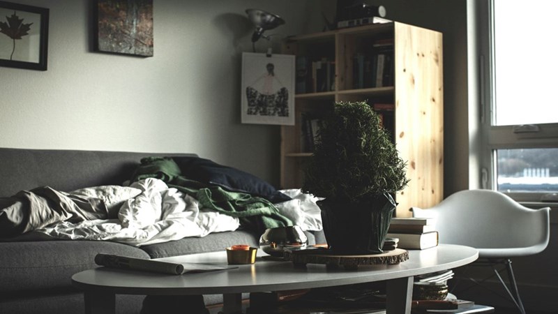 A disorganized room full of misplaced clothes.