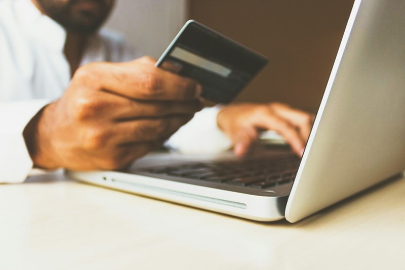 A person using a credit card to pay for something they bought on the internet. Stock photography for depiction only.