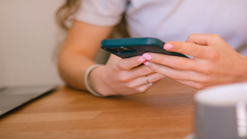 A woman using her phone. Model portrayal.
