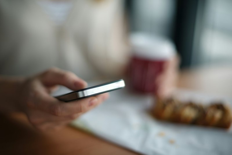 A man using his phone. Image for illustrative purposes.