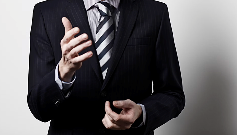 The boss gestures with his hands during a stern conversation.