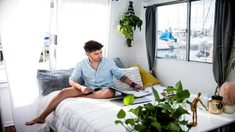 A student spending time in his college bedroom. Image for illustrative purposes.