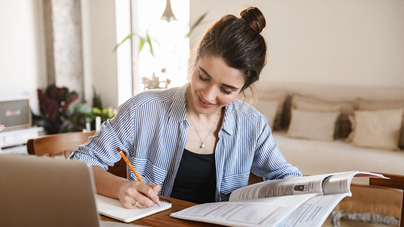 Young woman studying at home.