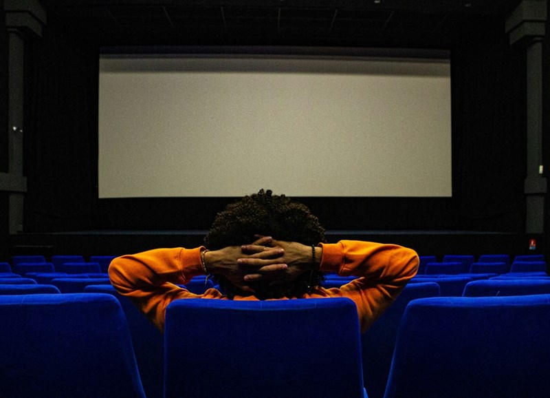 person sitting in a chair in front of projection screen