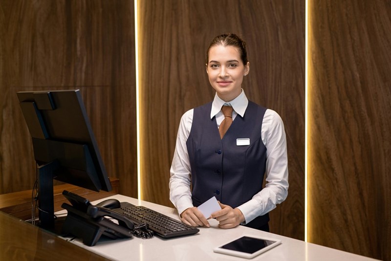 Receptionist at hotel front desk.