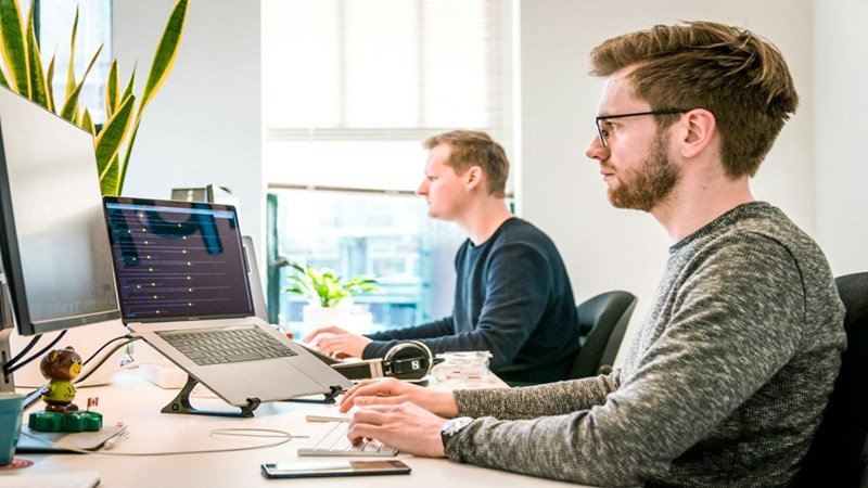 The two employees working in the same department of the office. Recreated scenario included to enhance reader understanding.