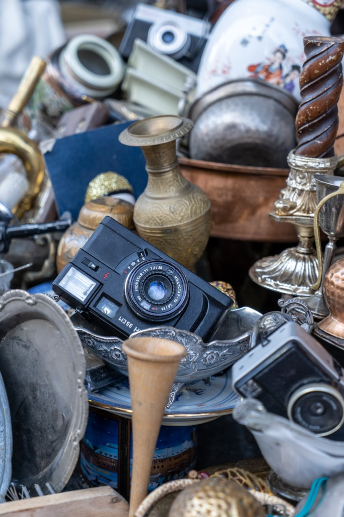 A pile of valuable belongings, including a camera, up for auction, representing the poster's stored goods. 