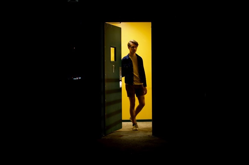 A tenant opens the door to a darkened bedroom
