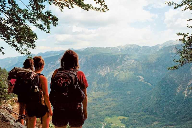 Friends escalating a mountain as an activity for their trip. Model portrayal.