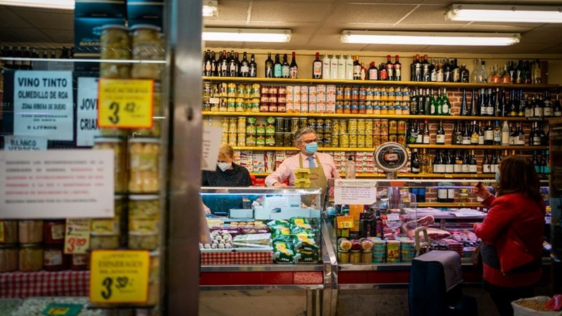 An employee attending a grocery store. Licensed media provided as editorial context.