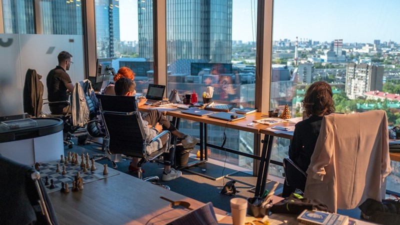 Workers work in a trendy modern office after their company pushed for return to office