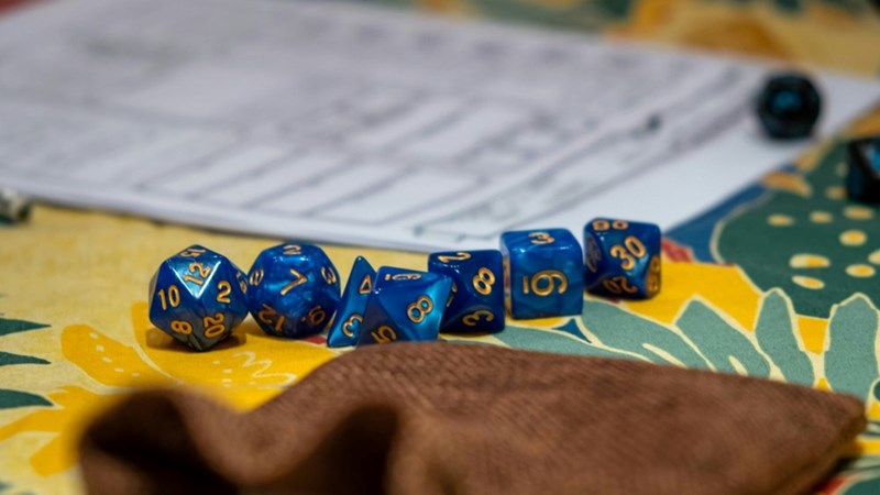 A table set to play Dungeons & Dragons with the dice placed.