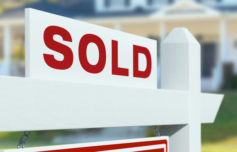 A sold sign out in front of a sold house