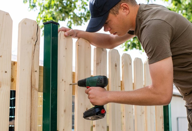 The neighbor building the fence.