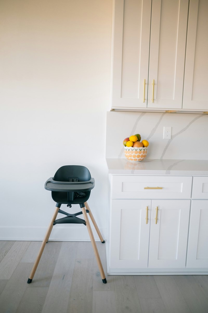 A high chair that hasn't been moved to the table yet. 