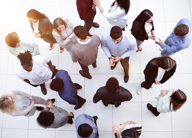overhead view of clusters of employees in a crowded work space