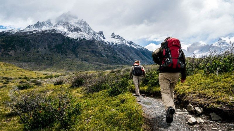 Two friends backpacking together. Image for illustrative purposes.