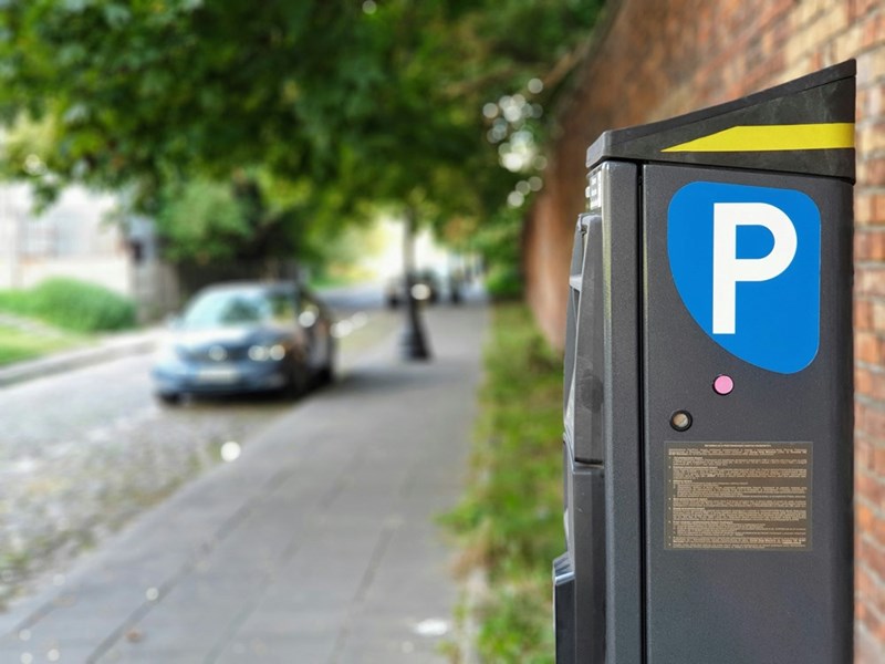 A parking meter at a parking lot, representing the charges to the employees in the story.