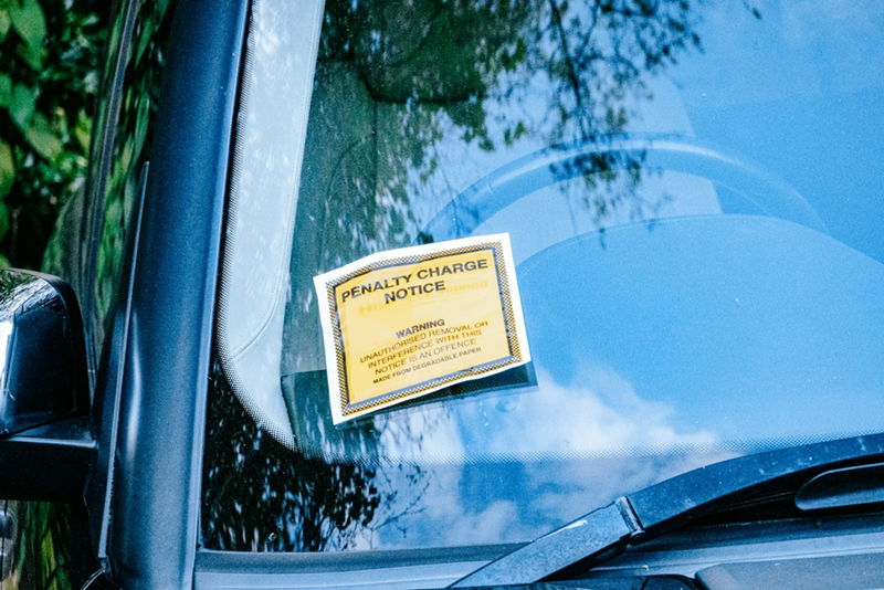 A parking notice on a car that hasn't paid the fine.