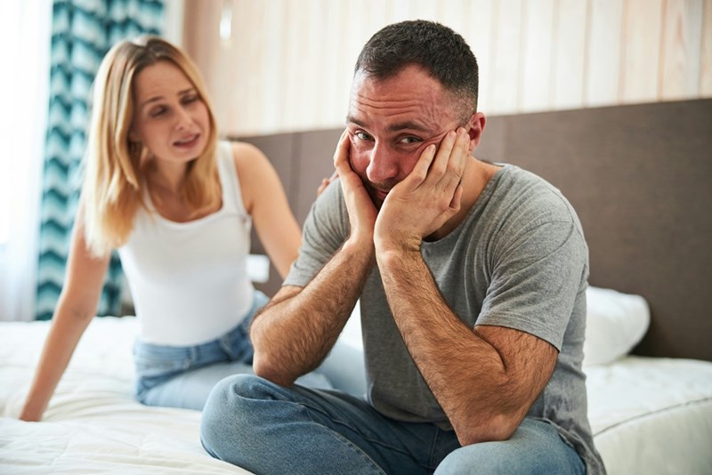 A frustrated couple discusses a stressful situation at home after a big argument with roommates over household decisions.